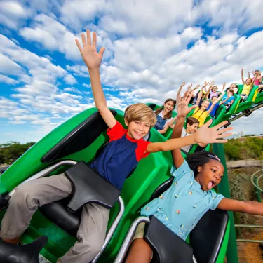 Kids riding the Dragon with their hands up at LEGOLAND California