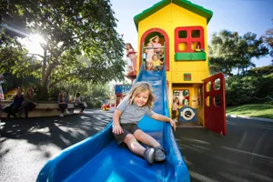 Kid sliding down play structure at DUPLO Playtown