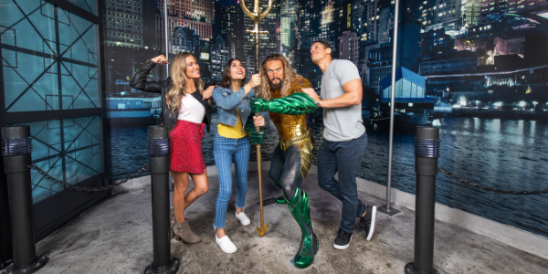 Group with Aquaman wax figure at Madam Tussauds