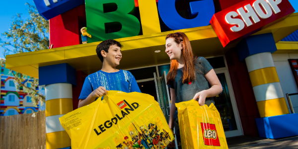 Children outside the BIG Shop with shopping bags