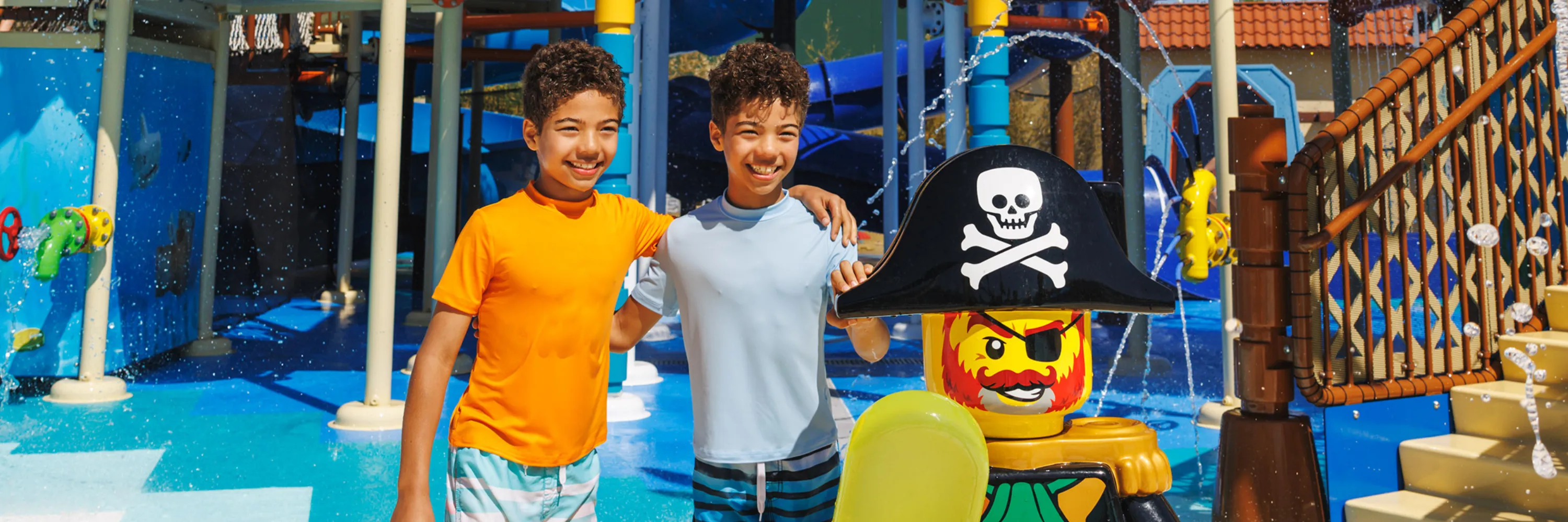 Kids next to Minifigure Pirate statue in Water Playground