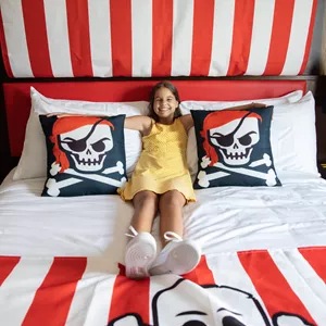 Girl Relaxes in a Pirate Room King Size Bed